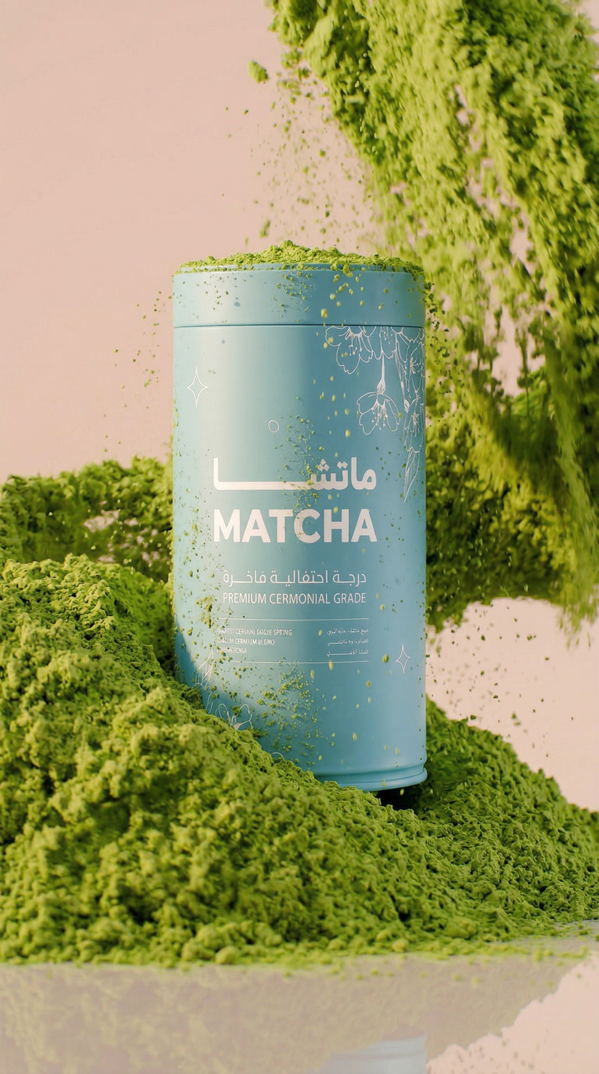 An OMatcha tin with green matcha powder cascading down around it against a soft peach background.