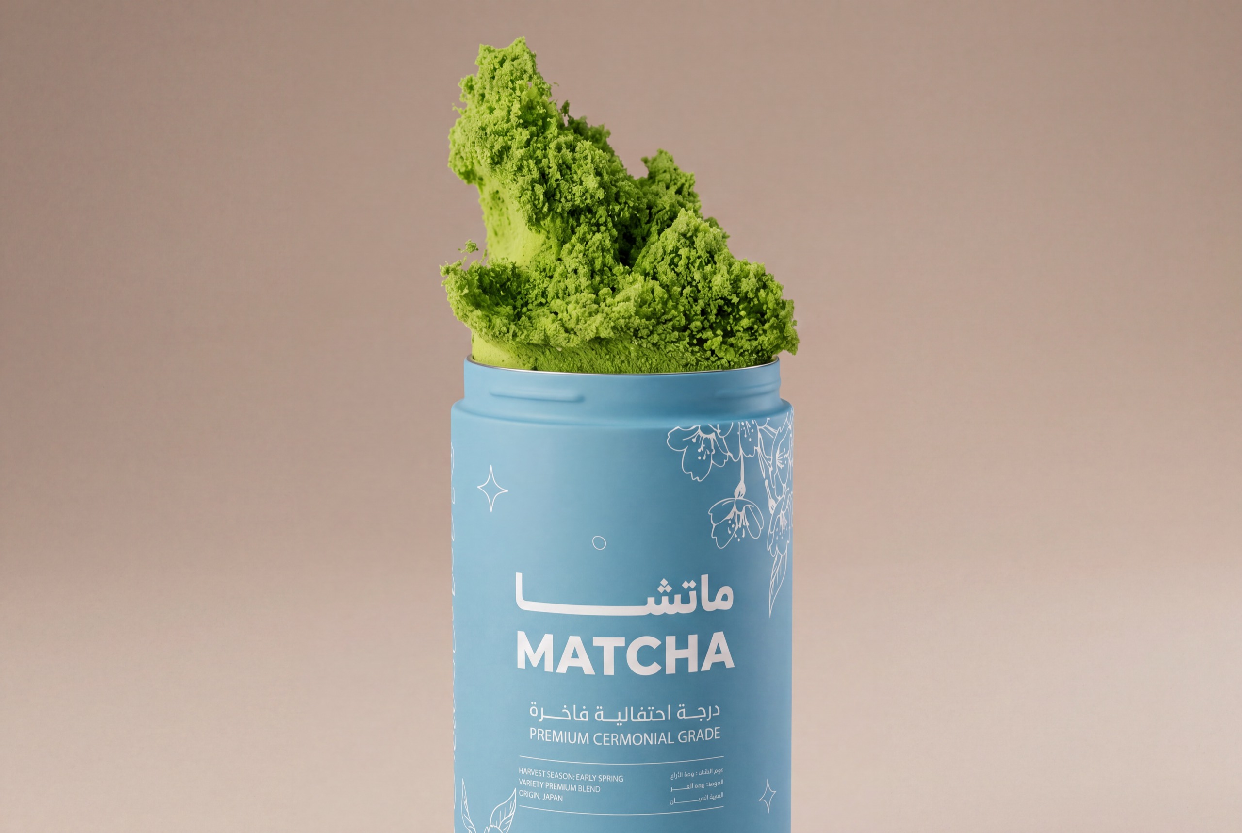 OMatcha — the same tin alone on a plain ground, and surrounded by cascading matcha powder — after